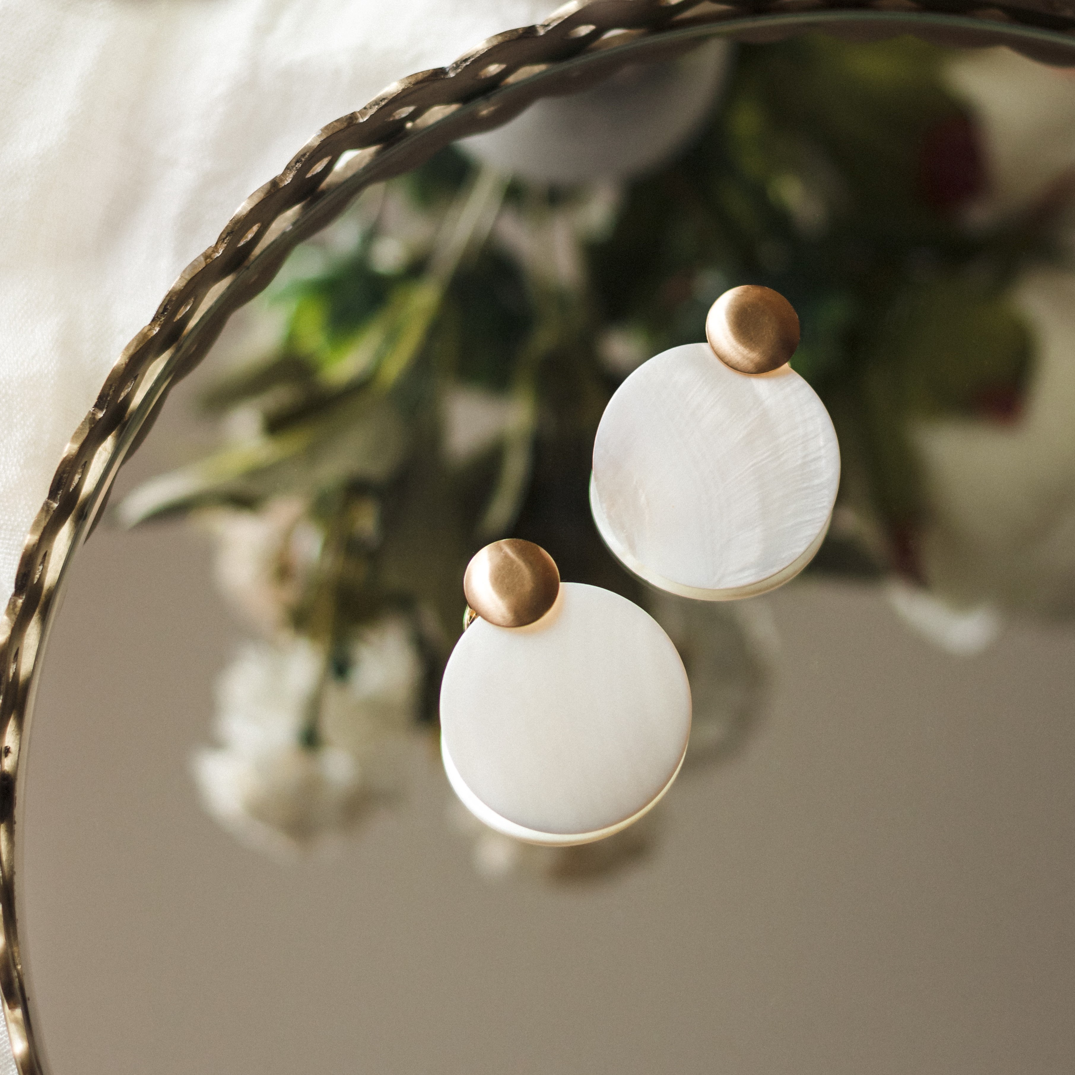 Very unique earrings with golden round top and the main lower part round and white