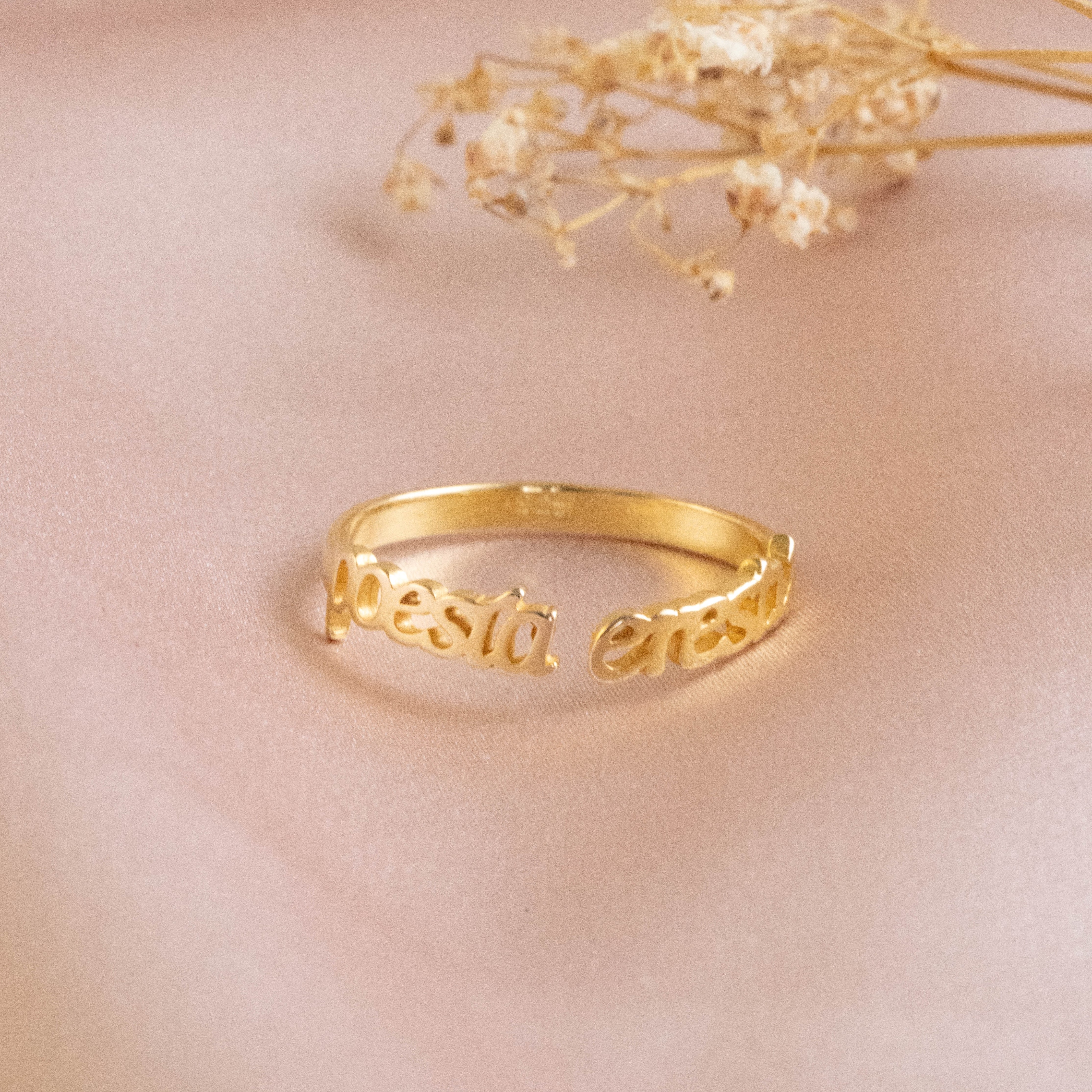 A gold ring with a quote