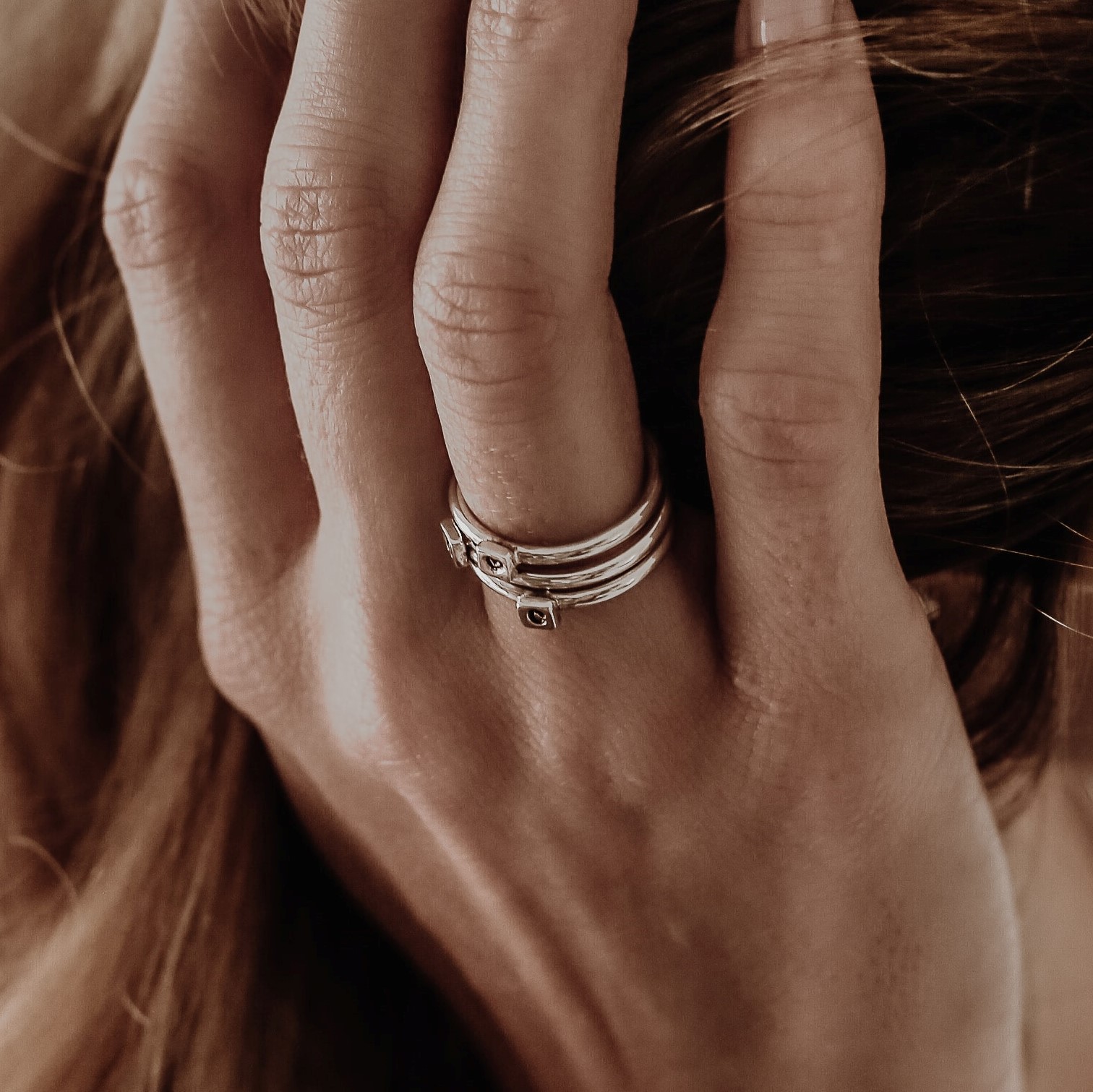 A rose gold ring with tiny pink elements