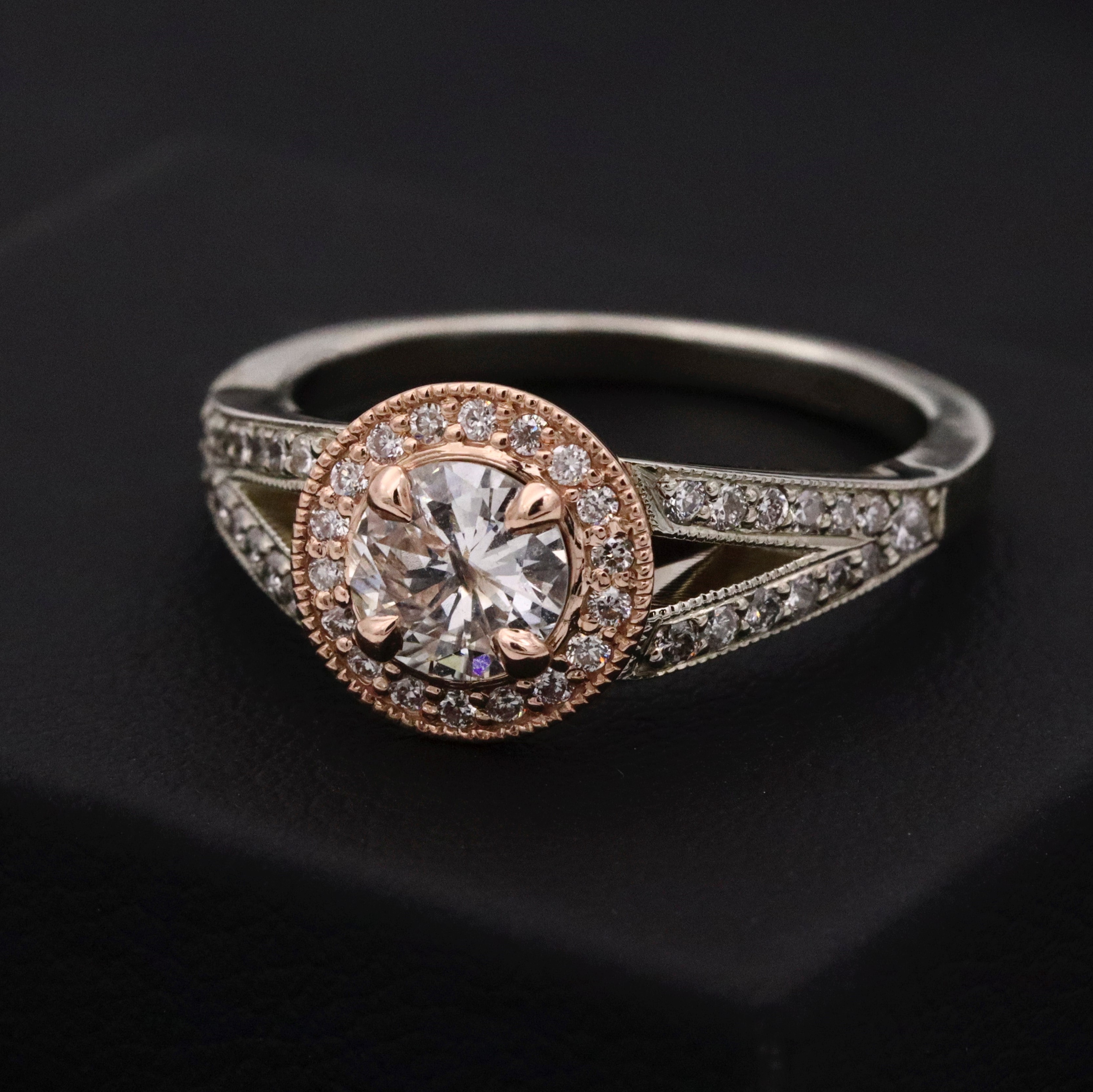 A diamond ring with multiple small diamonds around and one big main diamond