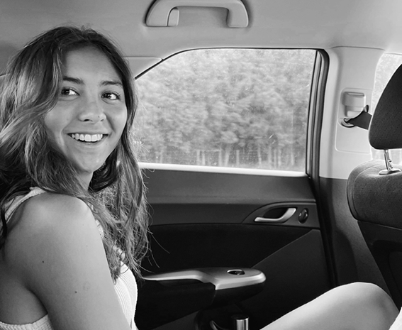 Hannah smiling in a car